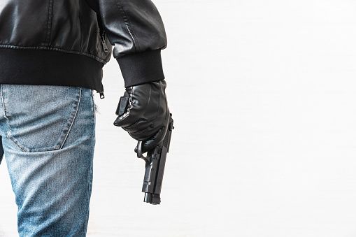 Hands holding gun isolated on white background. firearms for self-defense. The concept of legalizing the sale of weapons
