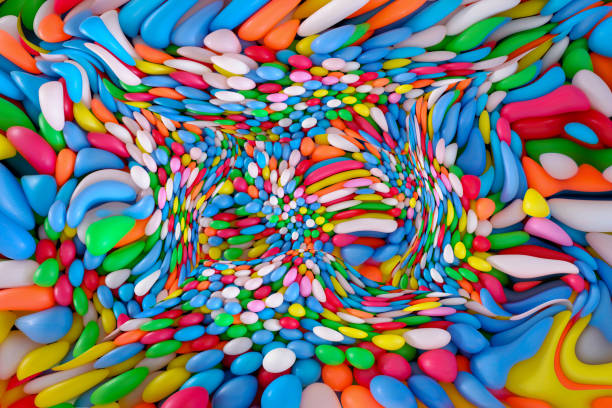 Multi colored, highly saturated plastic balls, in soft play ball pit, at a child's play park. Colorful balloon easter day concept.