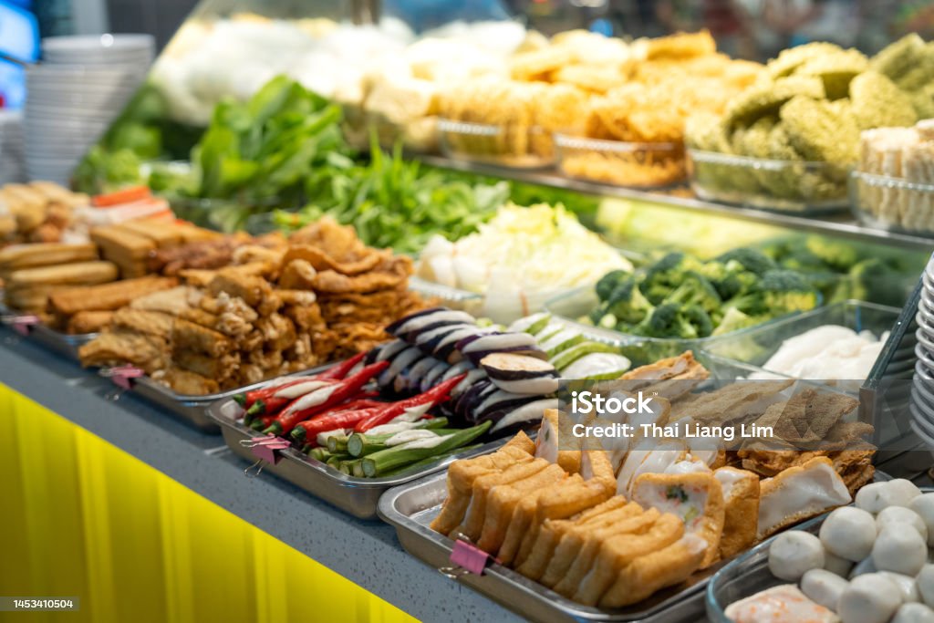 Yong tau foo, Hakka Chinese cuisine consisting of tofu filled with ground meat mixture or fish paste display on food stall Penang street food stall with various choices of vegetables, fish ball, bean curd and tofu filled with ground meat mixture or fish paste. Noodles Stock Photo