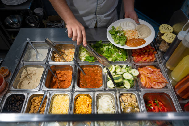 istock Chef preparing Arabic traditional breakfast with assorted salad with salad ingredients, high angle view. 1453411128