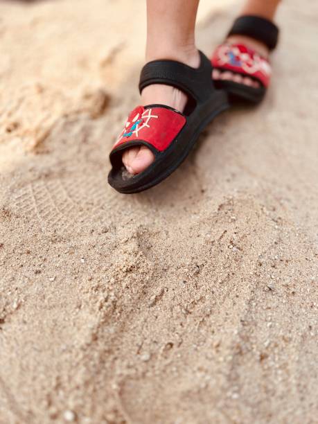 Feet of women who walk the sandy beach. Shooting Location: Thailand, Pattaya