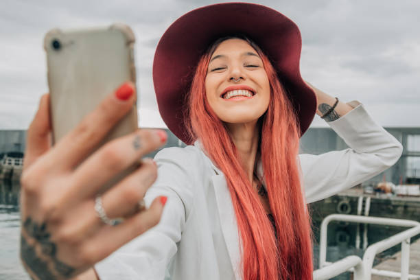 istock redhead influencer with mobile phone recording or taking photo 1453414531