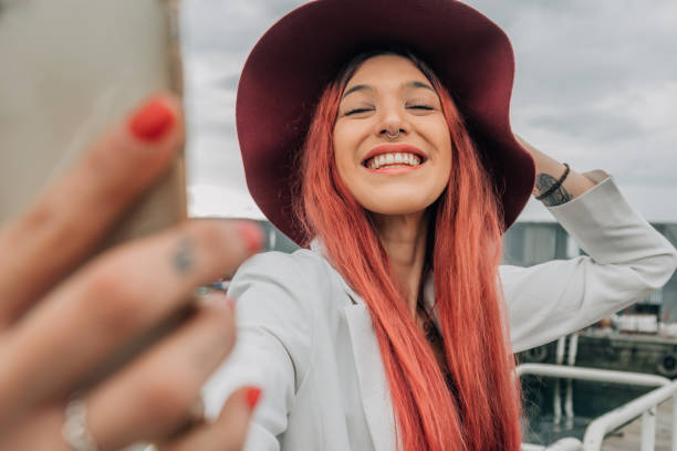 istock redhead influencer with mobile phone recording or taking photo 1453414535