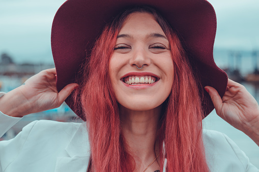 redhead young woman or girl with hat smiling happy