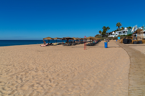 Almanci, Portugal – April 15, 2022: A beautiful view of the sandy Garrao Poente Beach in Almancil town , Portugal