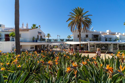 Almancil, Portugal – April 15, 2022: A beautiful view of restaurants under the blue sky on the coast of Almancil town in Portugal