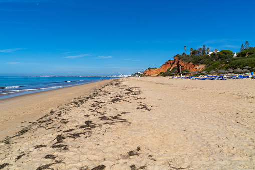 Almanci, Portugal – April 15, 2022: A beautiful view of the sandy Garrao Poente Beach in Almancil town , Portugal
