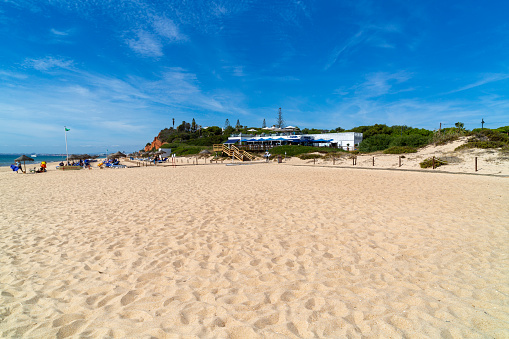 Almanci, Portugal – April 15, 2022: A beautiful view of the sandy Garrao Poente beach in Almancil town , Portugal