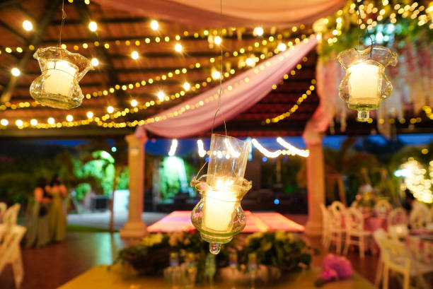 istock Wedding reception venue decorated with string lights and candles 1453424044