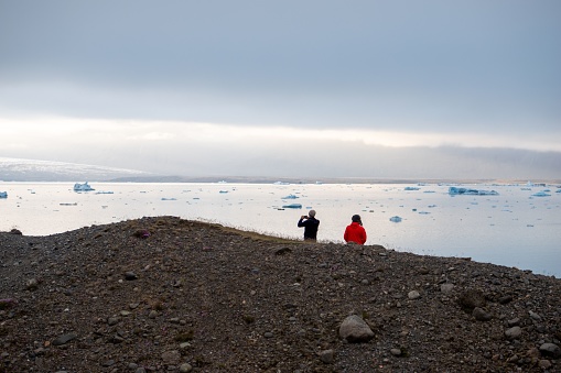 The people taking photos in the Jokulsarlon Glacier Lagoon Iceland
