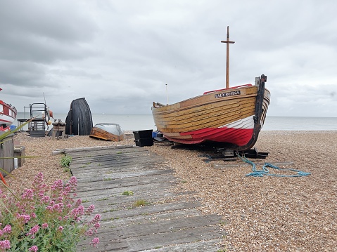 Hastings, United Kingdom – October 12, 2022: A fishing boat on the pebble beach, Hastings, East Sussex, England
