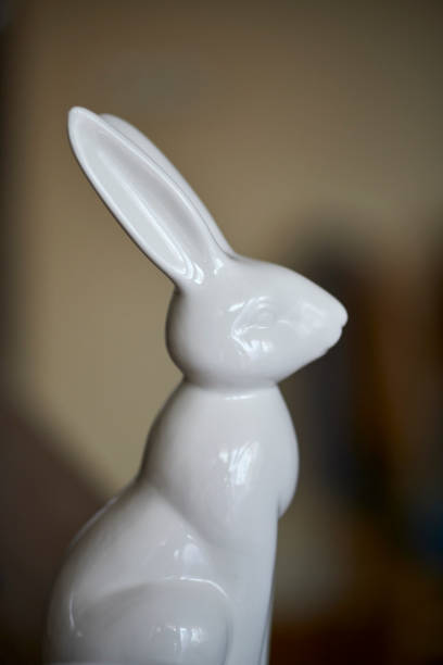 istock Vertical closeup of a white Easter bunny statue. 1453426672