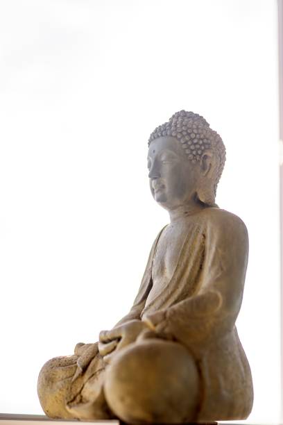 istock Close-up of buddha sculpture against sky 1453428704