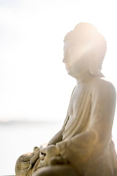 istock Close-up of buddha sculpture against sky 1453428705