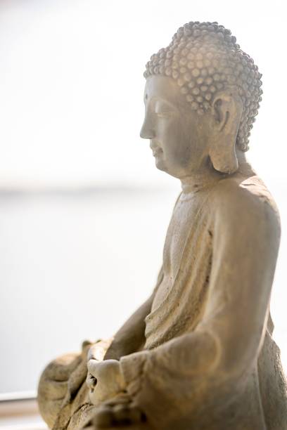 istock Close-up of buddha sculpture against sky 1453428715