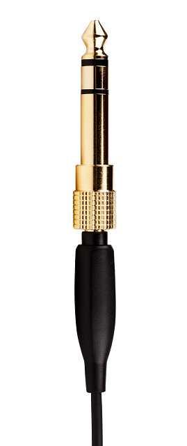 A vertical shot of a golden audio plug isolated on a white background