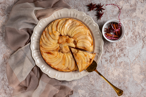 Delicious apple tart on concrete background, flat lay