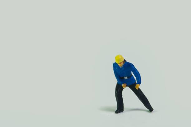 istock Miniature figure of a fireman standing on a white background 1453435345