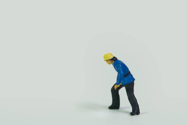 A miniature figure of a fireman standing on a white background
