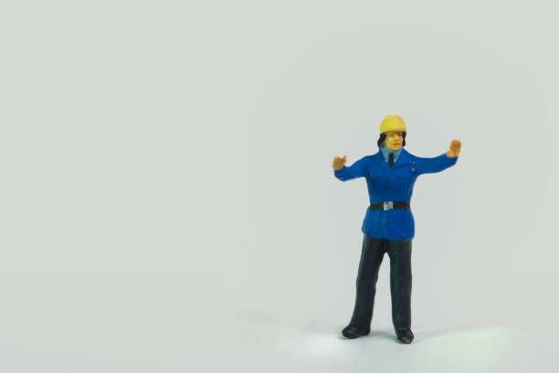 istock Miniature figure of a fireman standing on a white background 1453435369