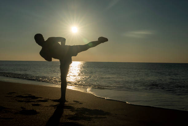istock young man doing shadow boxing on the beach 1453438715