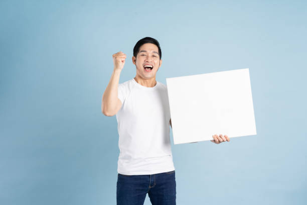 istock portrait of asian man posing on blue background 1453440575