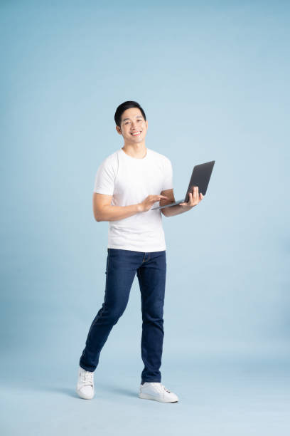 istock portrait of asian man posing on blue background 1453444439