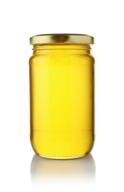 istock Glass jar of honey isolated. 1453448509