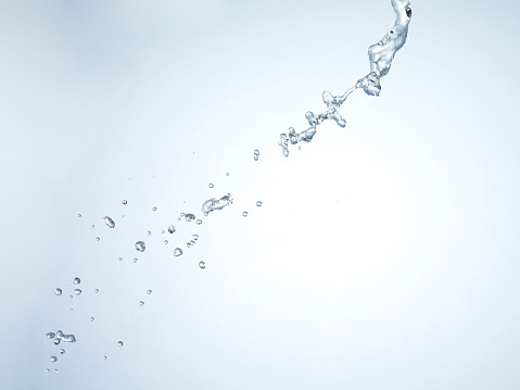 Water splashing from a fountain against a black background