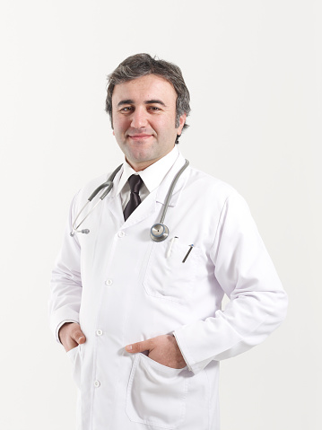 healthcare, profession and medicine concept - smiling male doctor with stethoscope in white coat over white background