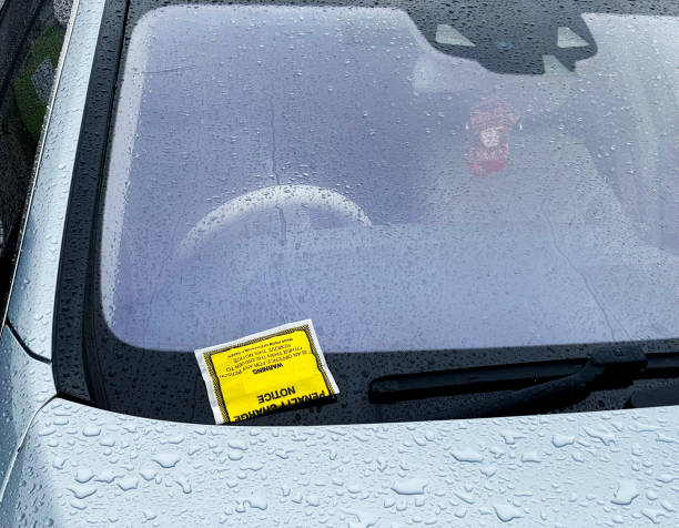 istock Parking ticket on a car in the rain 1453457691