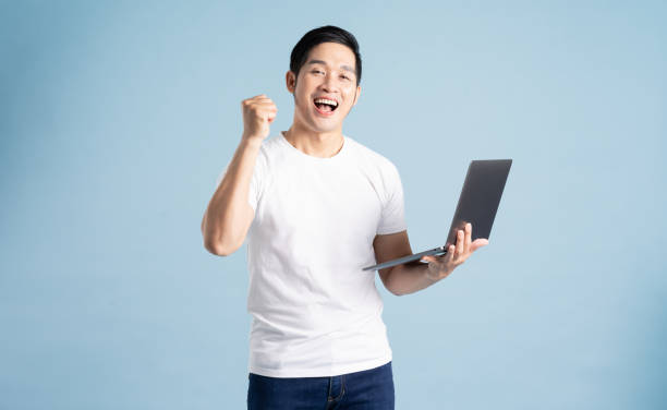 istock portrait of asian man posing on blue background 1453461294