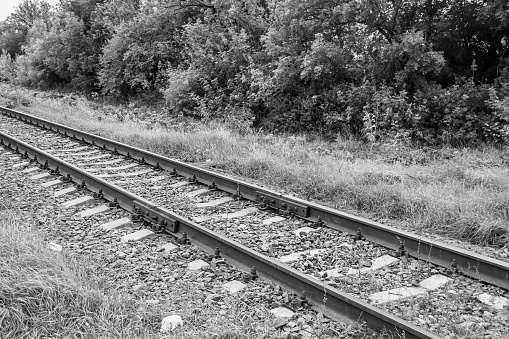 Photography to theme railway track after passing train on railroad, photo consisting of long railway track before fast movement train by railroad, railway transportation track for train at railroad