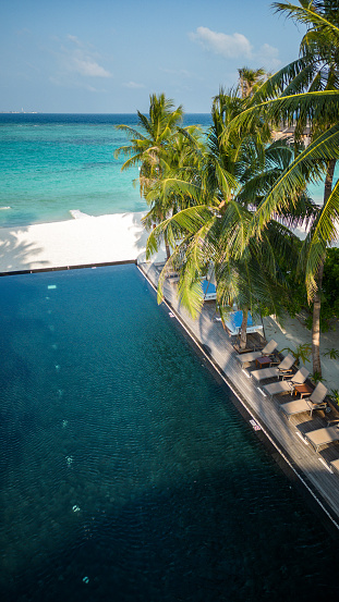 Maldives swimming pool at tropical Island Resort Hotel Beach with aerial drone view