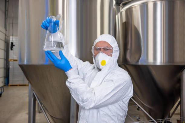 istock Serious technologist in protective gear working in the factory 1453463716