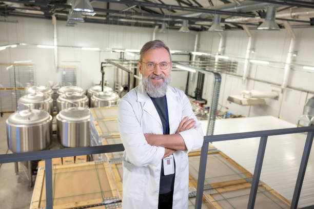 istock Confident brewer posing for the camera against beer fermentation tanks 1453463732