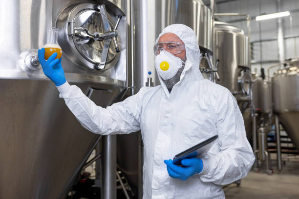 istock Brewery technologist with a sample of beverage in a vessel 1453463865