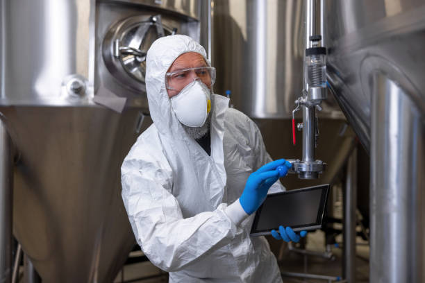 istock Experienced technologist in protective clothing testing the brewing equipment 1453463894