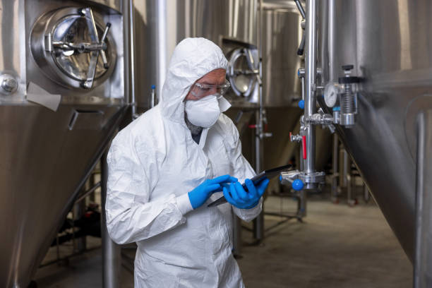 istock Brewer in protective clothing working at a beer plant 1453463900