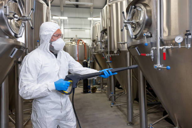istock Experienced beer tech cleaning and sanitizing the brewing equipment 1453463905
