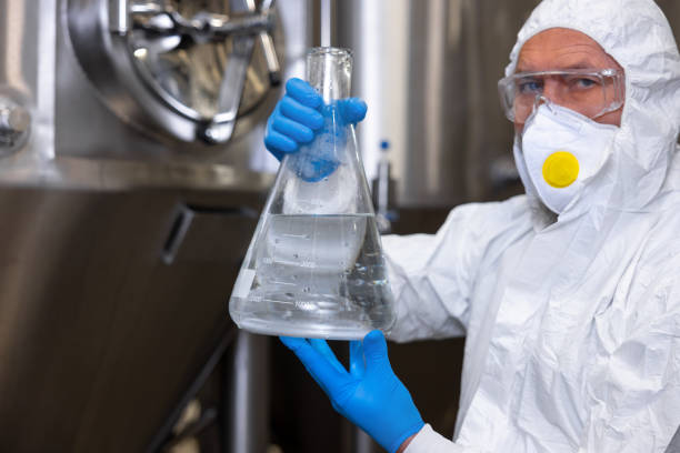 istock Brewer showing a vessel with a beverage before the camera 1453463917