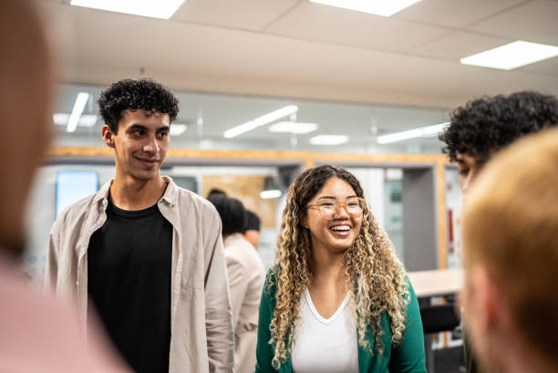 istock Young students talking with colleagues at university 1453464216
