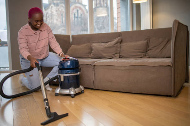 istock Woman cleaning floor with vacuum cleaner 1453464535