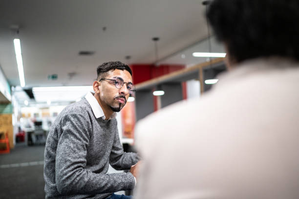 istock Mid adult man talking at university or office 1453465596