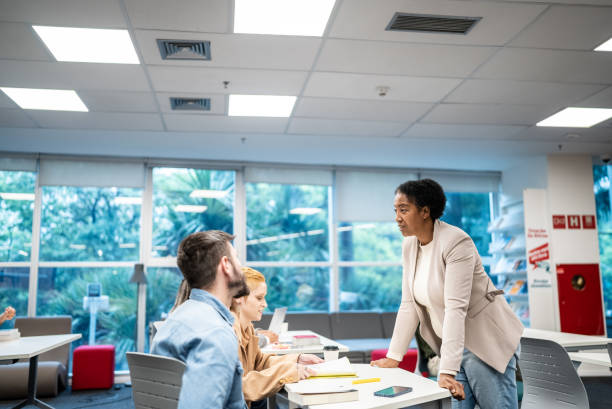 istock Teacher talking to university students at classroom 1453465859