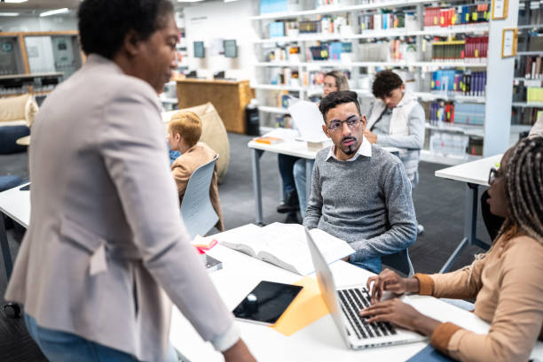 istock Teacher talking to university students at classroom 1453466457