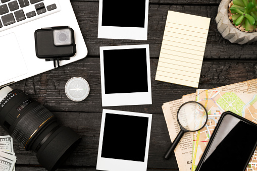 Traveling gadgets on wood table background