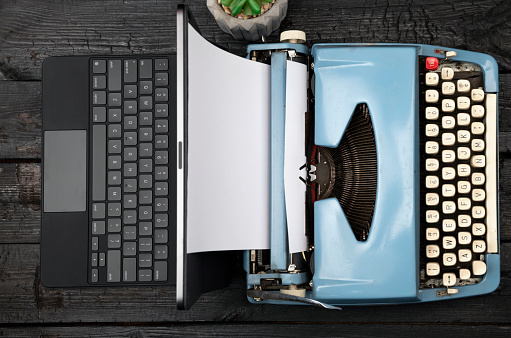 Modern Laptop Computer with Antique Typewriter