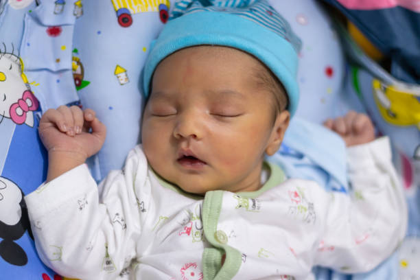 istock newborn baby isolated sleeping in white cloth from different angle 1453471429