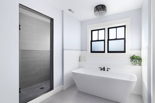 istock A white standalone tub and grey tiled shower. 1453472687